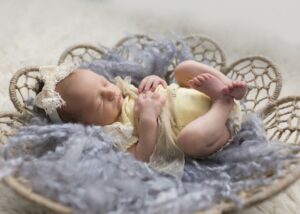 adorable newborn girl in yellow outfit