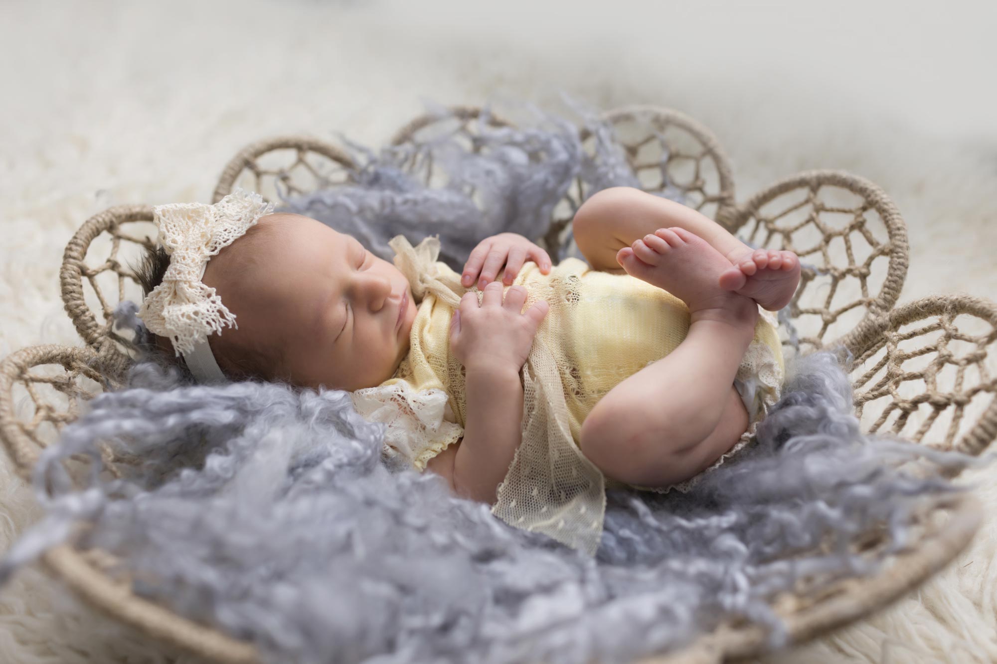 adorable newborn girl in yellow outfit