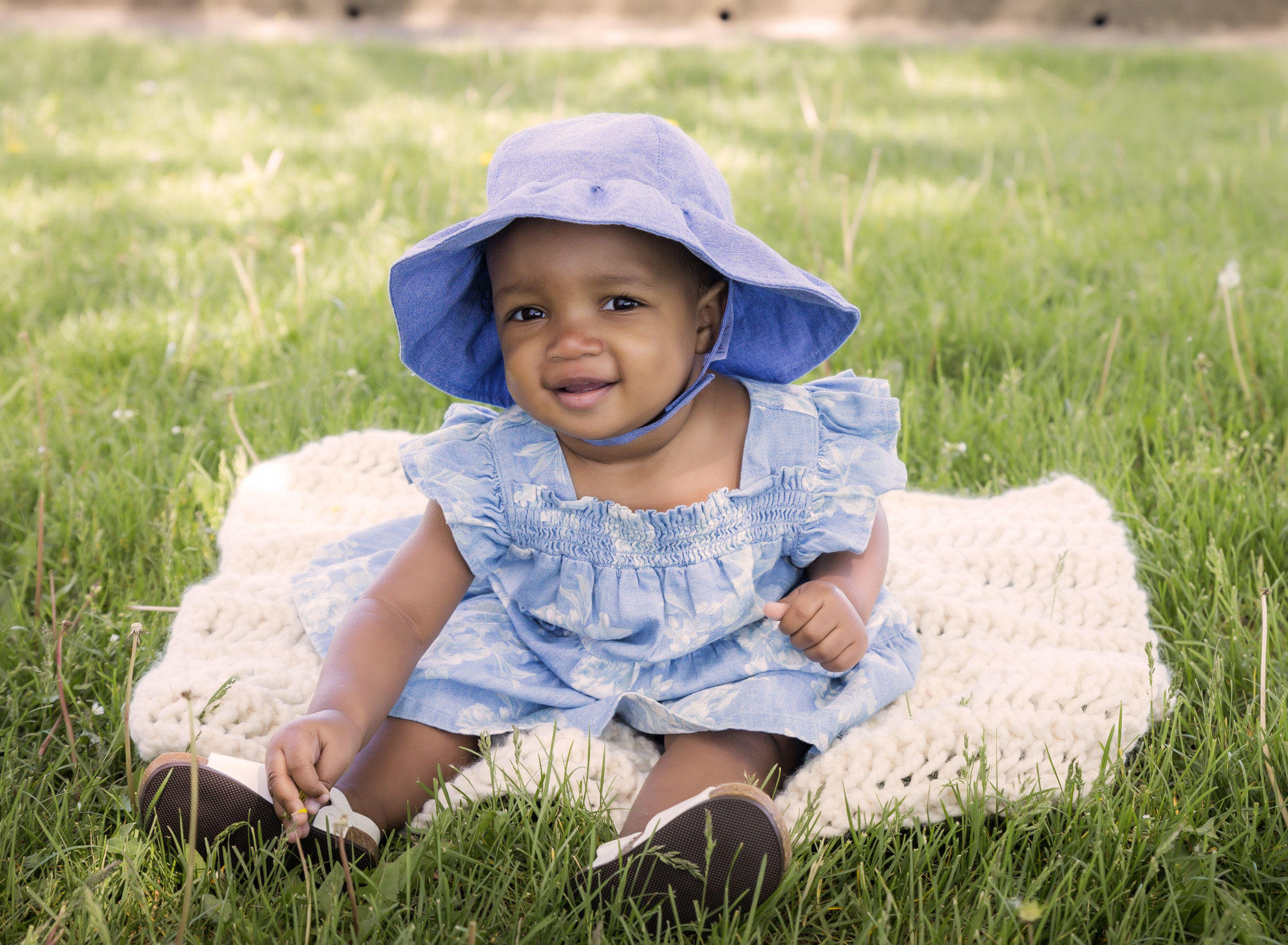 baby girl in denim hat looking at camera