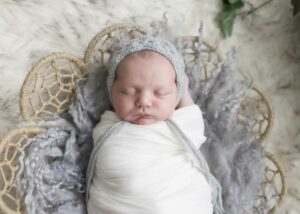 newborn baby in basket homepage