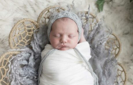 newborn baby in basket homepage
