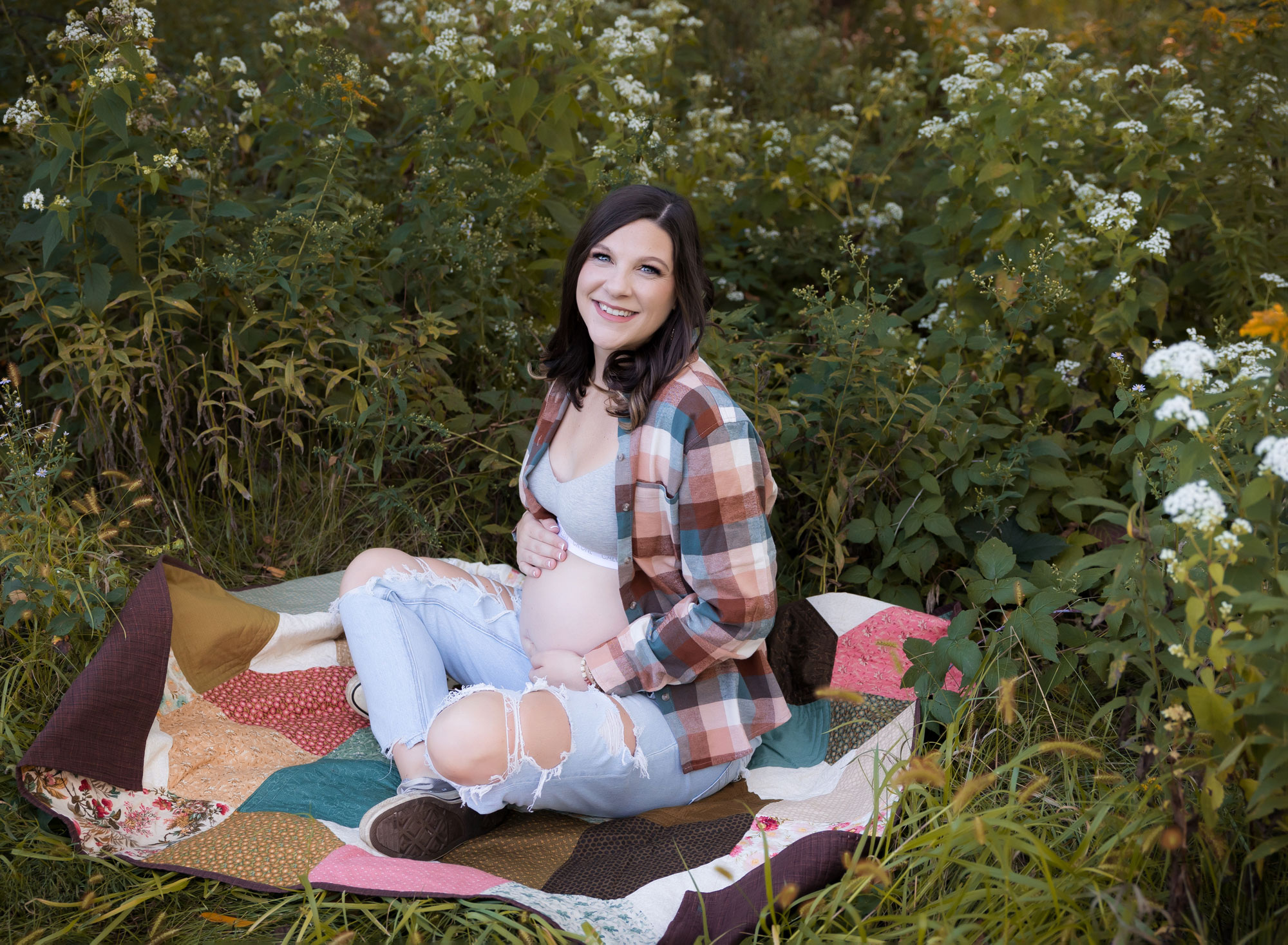 pregnant woman sitting on colorful blanket