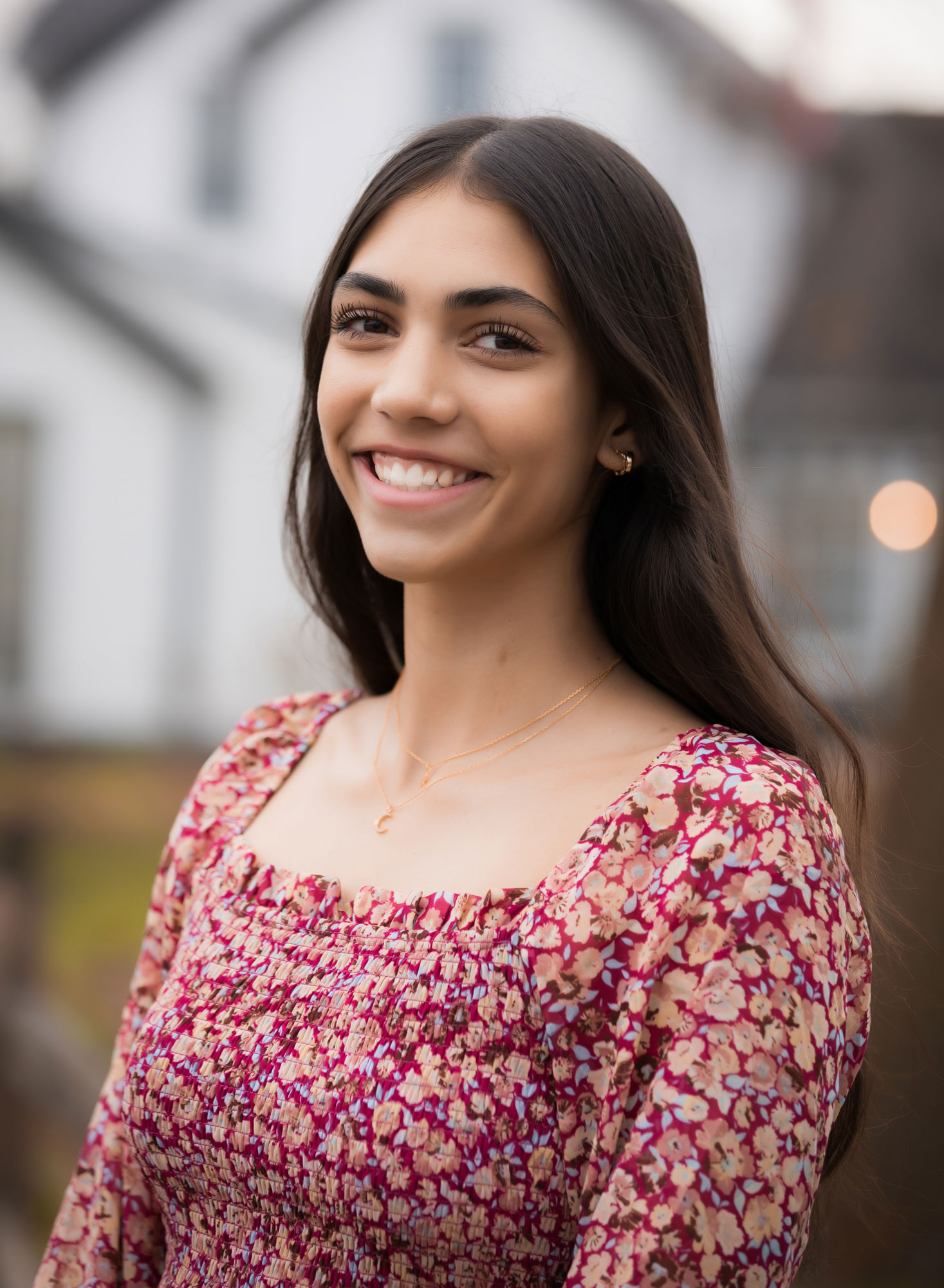 senior girl with floral top smiling