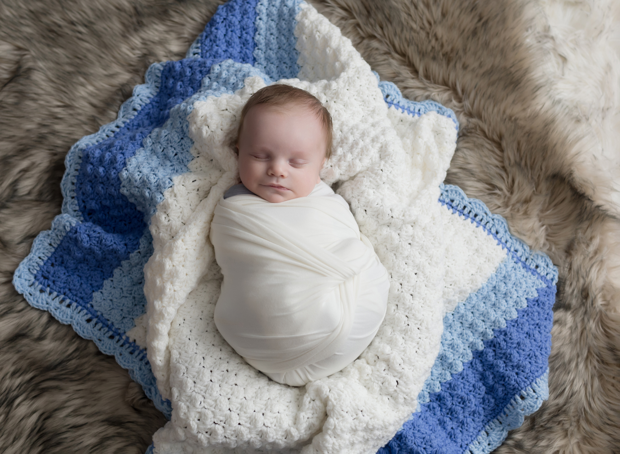 sweet-baby-boy-on-blue-and-white-blanket
